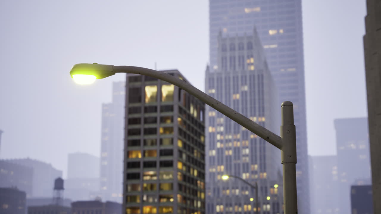 Urban streetlight illuminating downtown buildings at dusk in a modern city