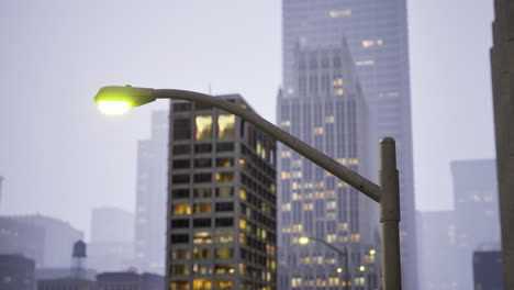 urban streetlight illuminating downtown buildings at dusk in a modern city