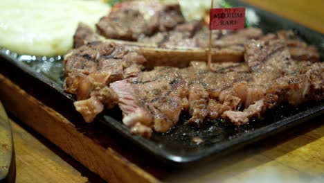 medium rare steak with side dishes