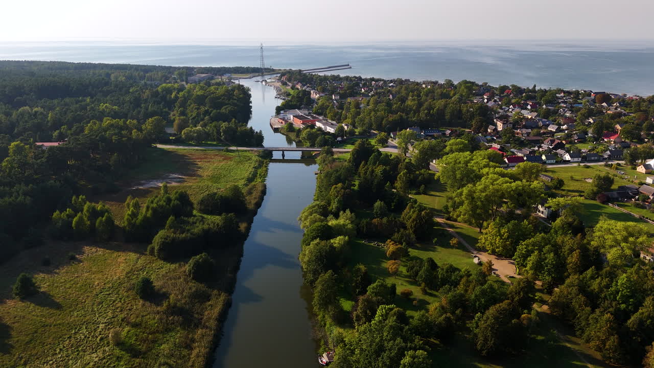 Saka River Through Coastal Town Of Pavilosta In South Kurzeme, Latvia. aerial shot