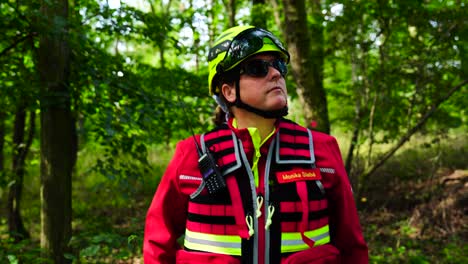 woman in red uniform, green helmet and dark sunglasses while in forest, czechia