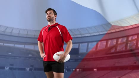 professional rugby player standing in front of a flag and stadium