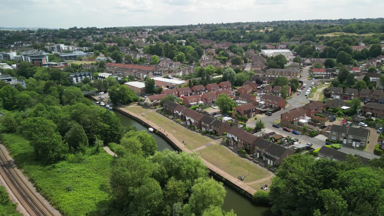 Aerial tracking shot through Maidstone streets and rooftops with trees and light traffic