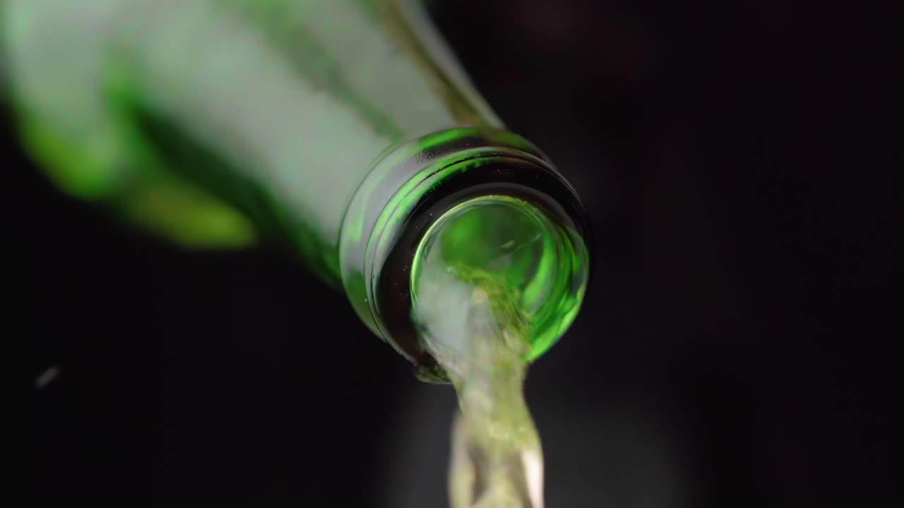 líquido que fluye de una botella verde transparente