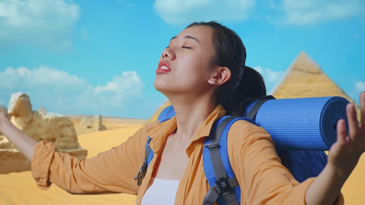 Close Up Side View Of Asian Female Hiker With Mountaineering Backpack Spreading Arms Enjoy Looking The View Around While Traveling In Pyramid Of Giza