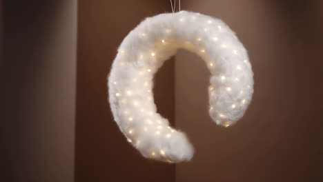 fluffy crescent moon decoration with warm fairy lights