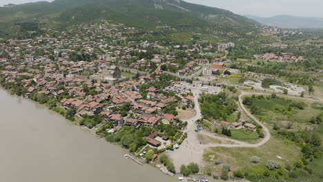 residential house and svetitskhoveli cathedral in mtskheta town from mtkvari river in georgia