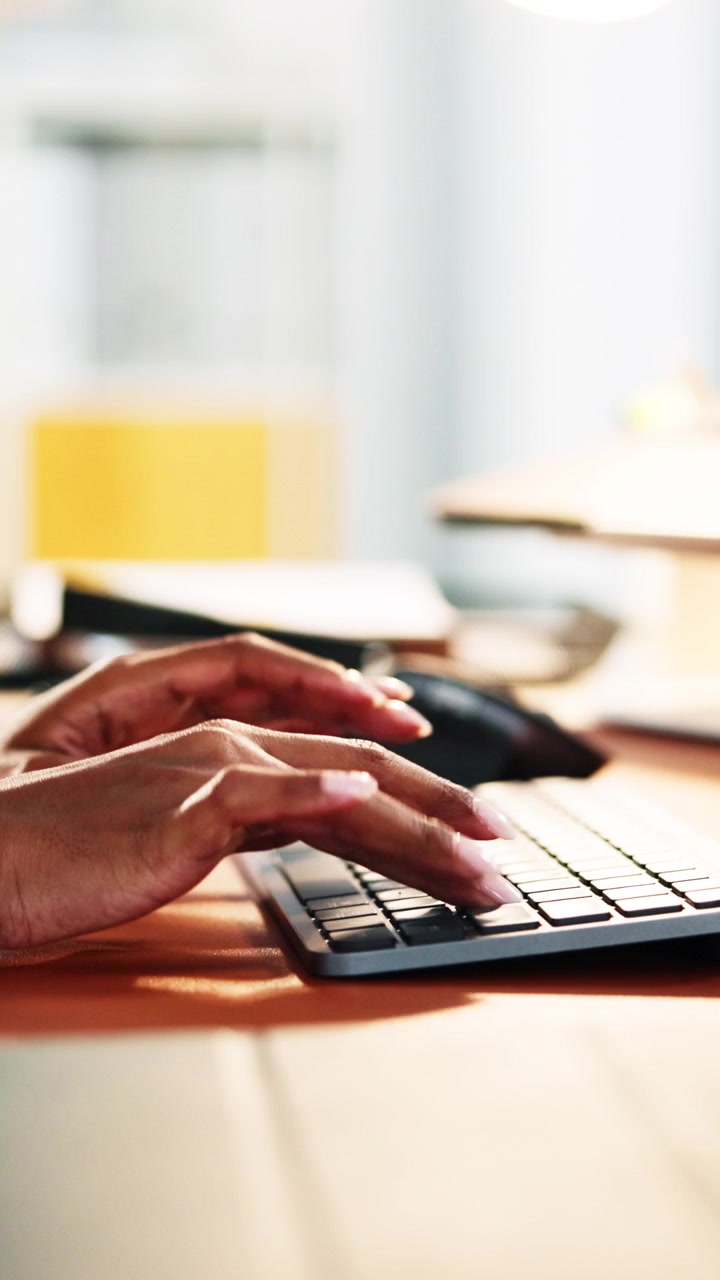 Close-up of Person Typing on Wireless Keyboard in Office