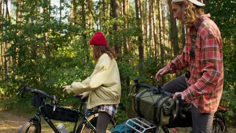 couple cycling in the forest