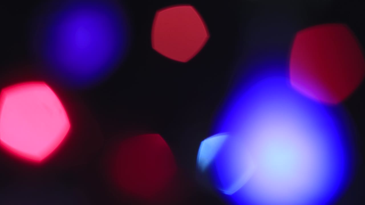 Out of focus Christmas colored lights flicker fabulously.