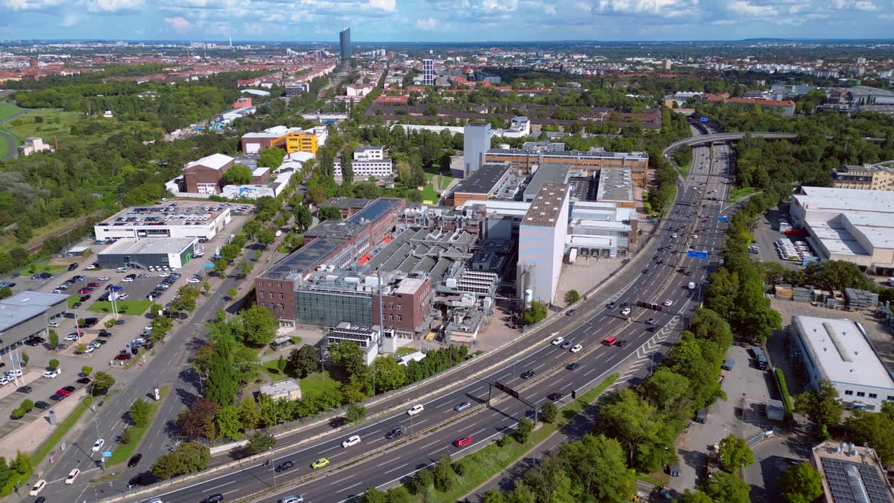 Aerial view of a cityscape with buildings and highway traffic