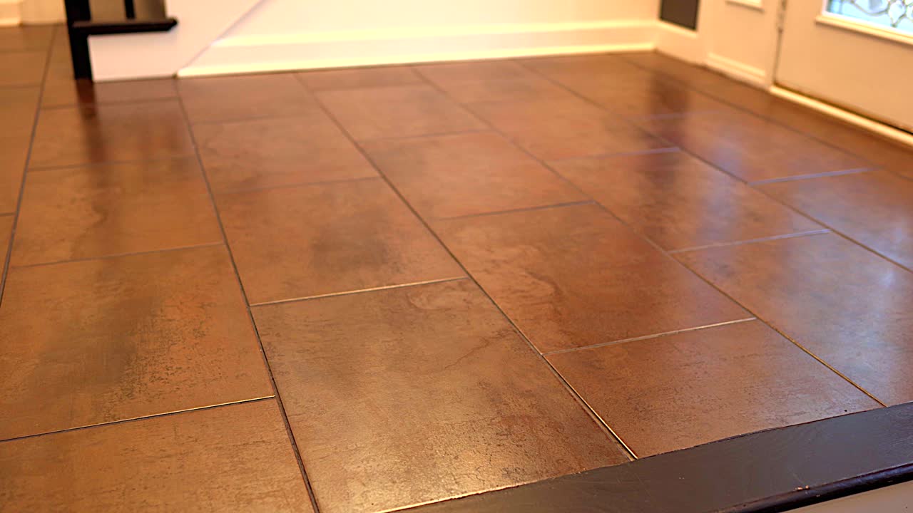 Big flooring tiles installed in beautiful home, tiles are made of ceramic material and with reddish textures