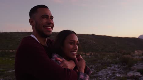 young couple on a road trip at dusk