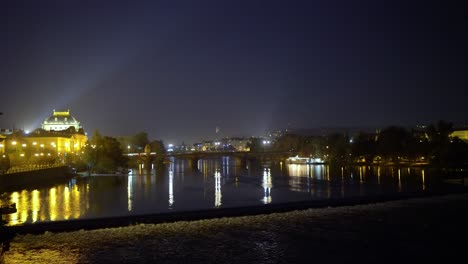 prague national theatre by the vltava's riverside at night, tighter framing