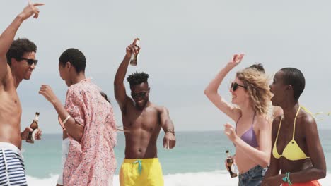 group of mixed-race friends dancing together on the beach 4k