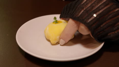 Colourful-sticky-Mochi-confectionary-taken-from-plate-in-Avant-Garde-restaurant,-Close-up