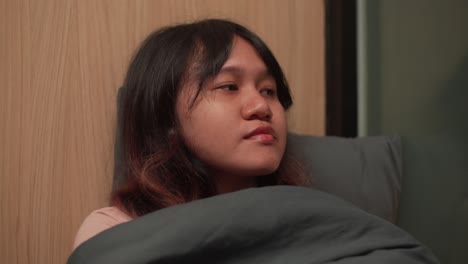 indonesian girl looks at the window