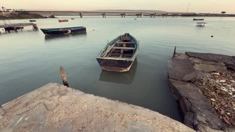 old boats at a river dock at sunset