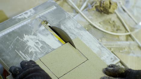 closeup small modern circular saw makes cut in ceramic tile