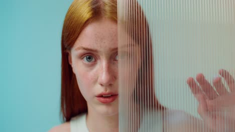 young woman with red hair in a studio setting