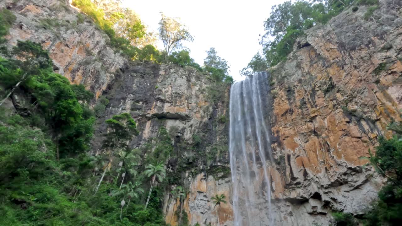 높은 폭포가 바위 절벽 아래로 떨어집니다.