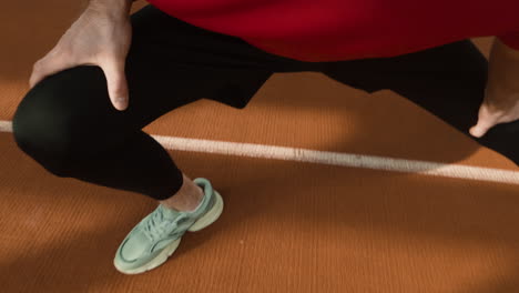 athlete stretching on a running track