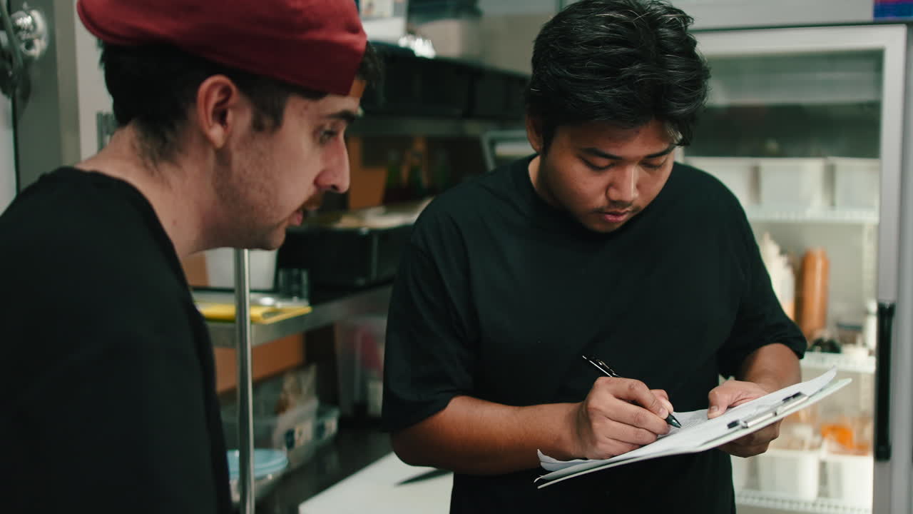 Two men working in a restaurant kitchen