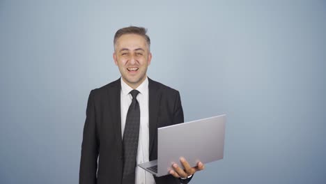 Businessman-relaxes-after-finishing-his-work-on-laptop.