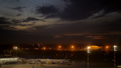 airport at night plane boarding and taking off