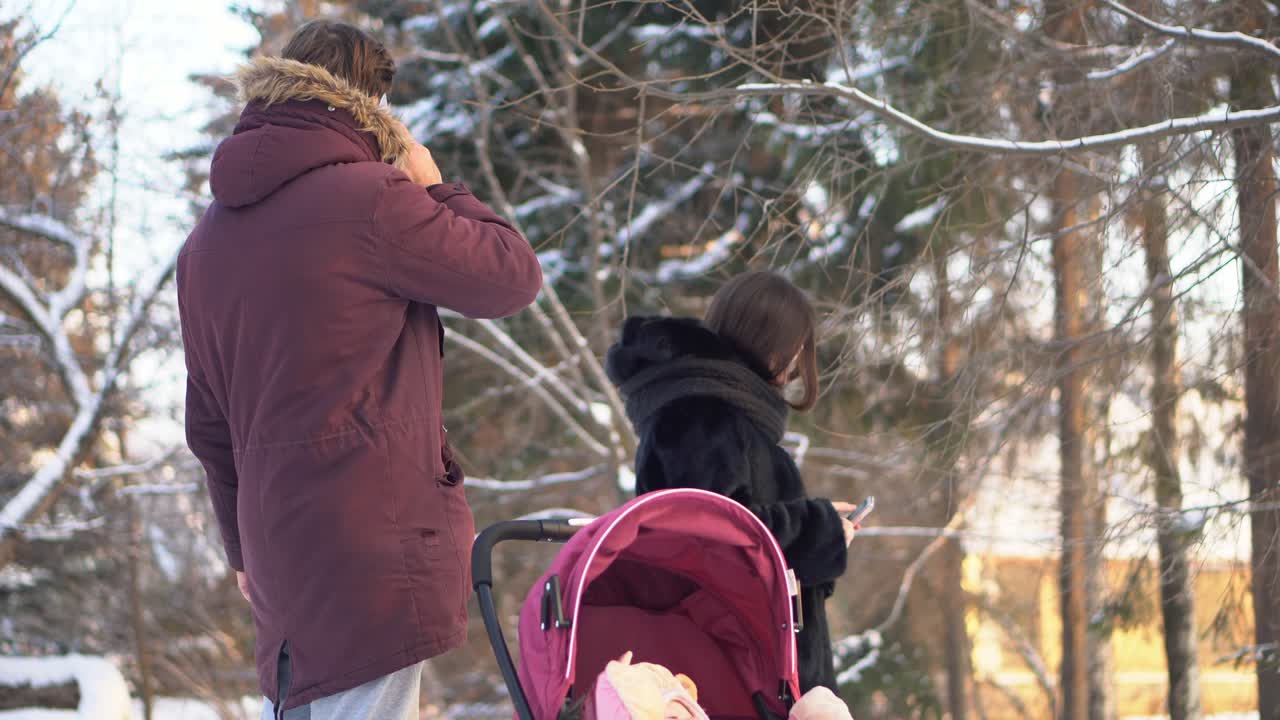 Пара с ребенком в зимнем парке