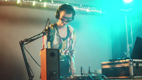 dj artist using clubbing mixing turntables at party