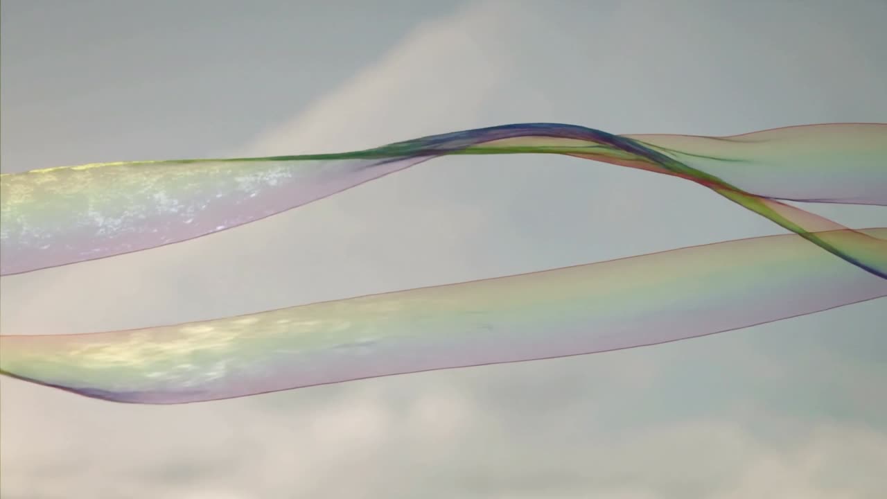 Drifting translucent iridescent ribbons sliding and crossing across pale sky with gentle breeze