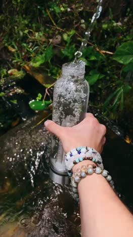 crystal water bottle by a stream