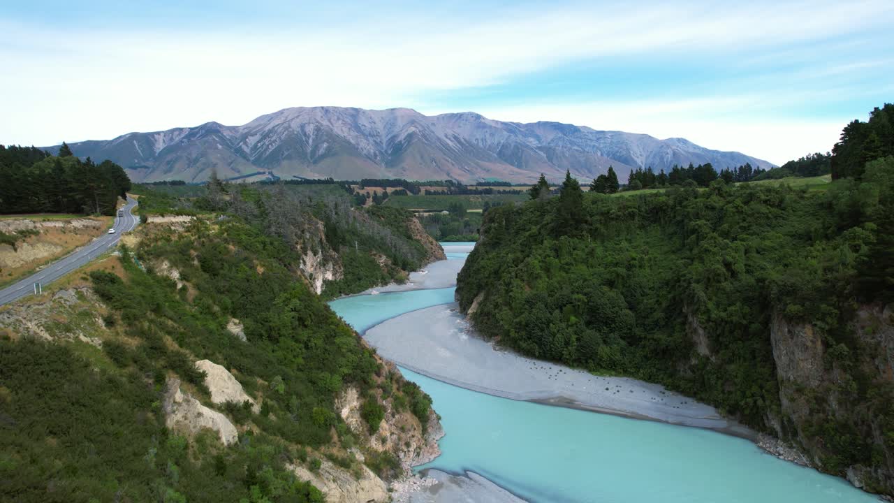 Aerial tracking shot of the Rakaia Gorge river, sunny day in New Zealand