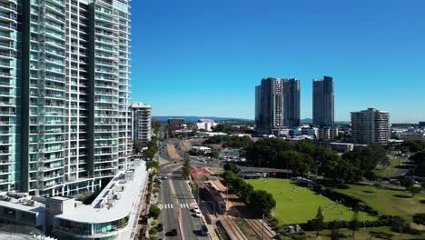 el tranvía eléctrico eficiente en energía viaja al suburbio de gold coast, southport, antes de detenerse en la estación de broadwater parklands.