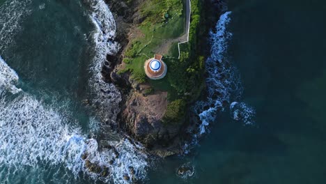 aerial top down shot of pavilion on hill surrounded by waves of ocean in summer - senator resort hotel,puerto plata