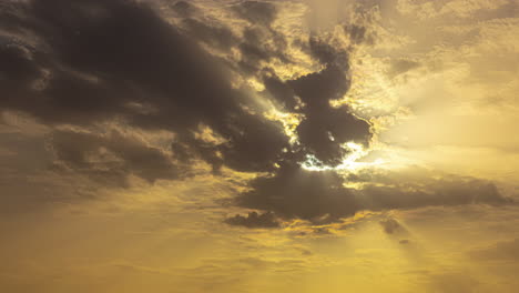 time lapse of dark black clouds consume bright golden yellow sunset