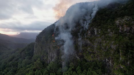 smoke rising from wildfire burning part of currumbin valley in queensland, australia