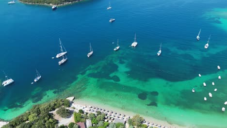 boats, coastline and green island at syvota, epirus, greece - aerial reveal