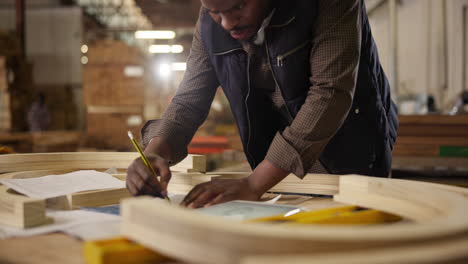 man working on woodworking project in workshop