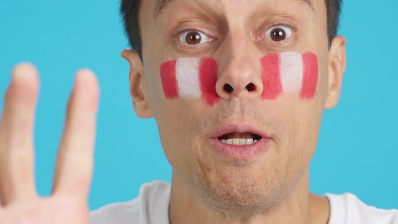 Close up of a man supporting peruvian team