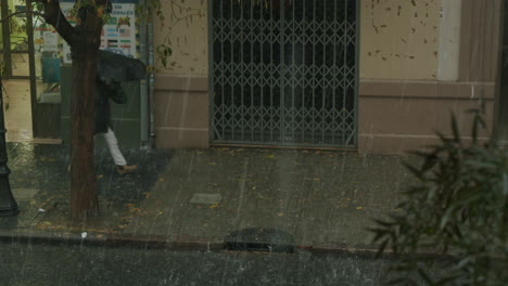 woman is in a hurry to get home and hide from the rain and hail