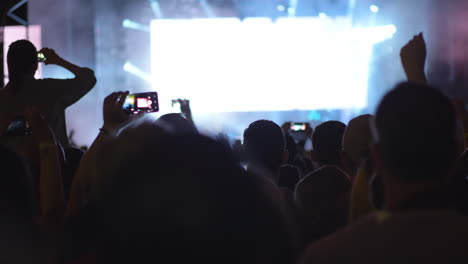 rock band performing in front of hundreds music fans