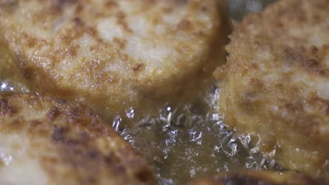 cooking homemade fried fish burger patty. frying fish patties with hot oil