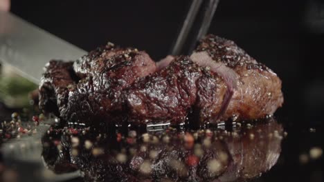 man cutting meat with a knife