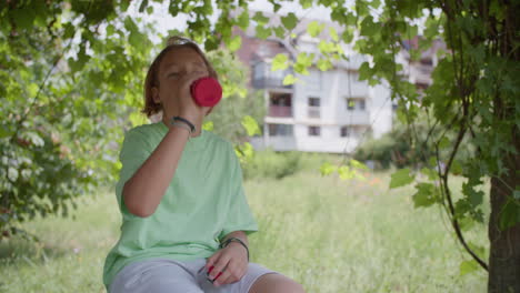 boy drinking water in the park