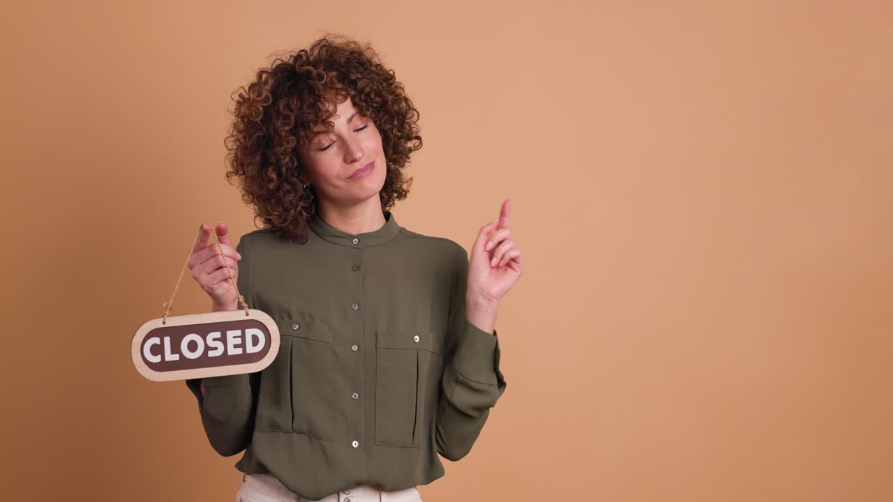 woman with closed sign on beige background