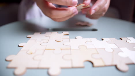 Close-Up-Hands-of-man-Connecting-Jigsaw-Puzzle-With-Sunlight-effect