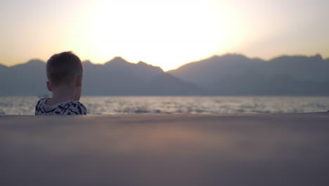 lonely child by the sea at sunset