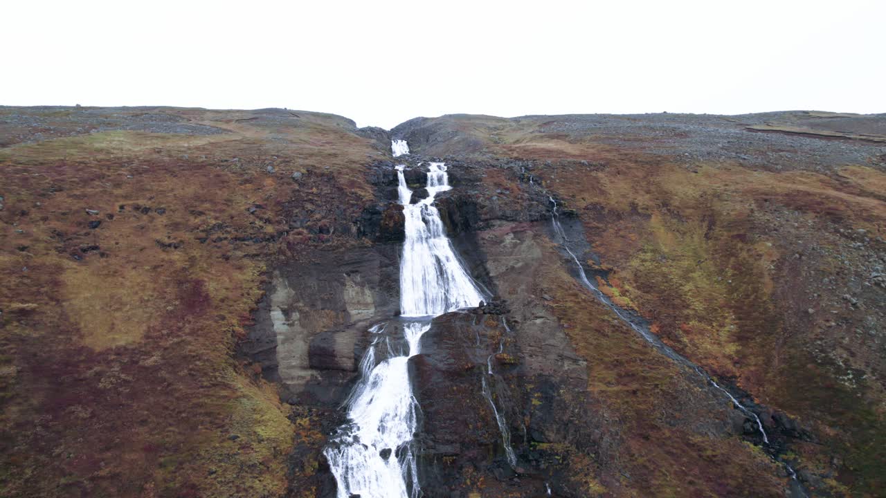 Aerial: pullback shot of Rjukandafoss waterfall, a hidden treasure amidst Iceland's pristine wilderness